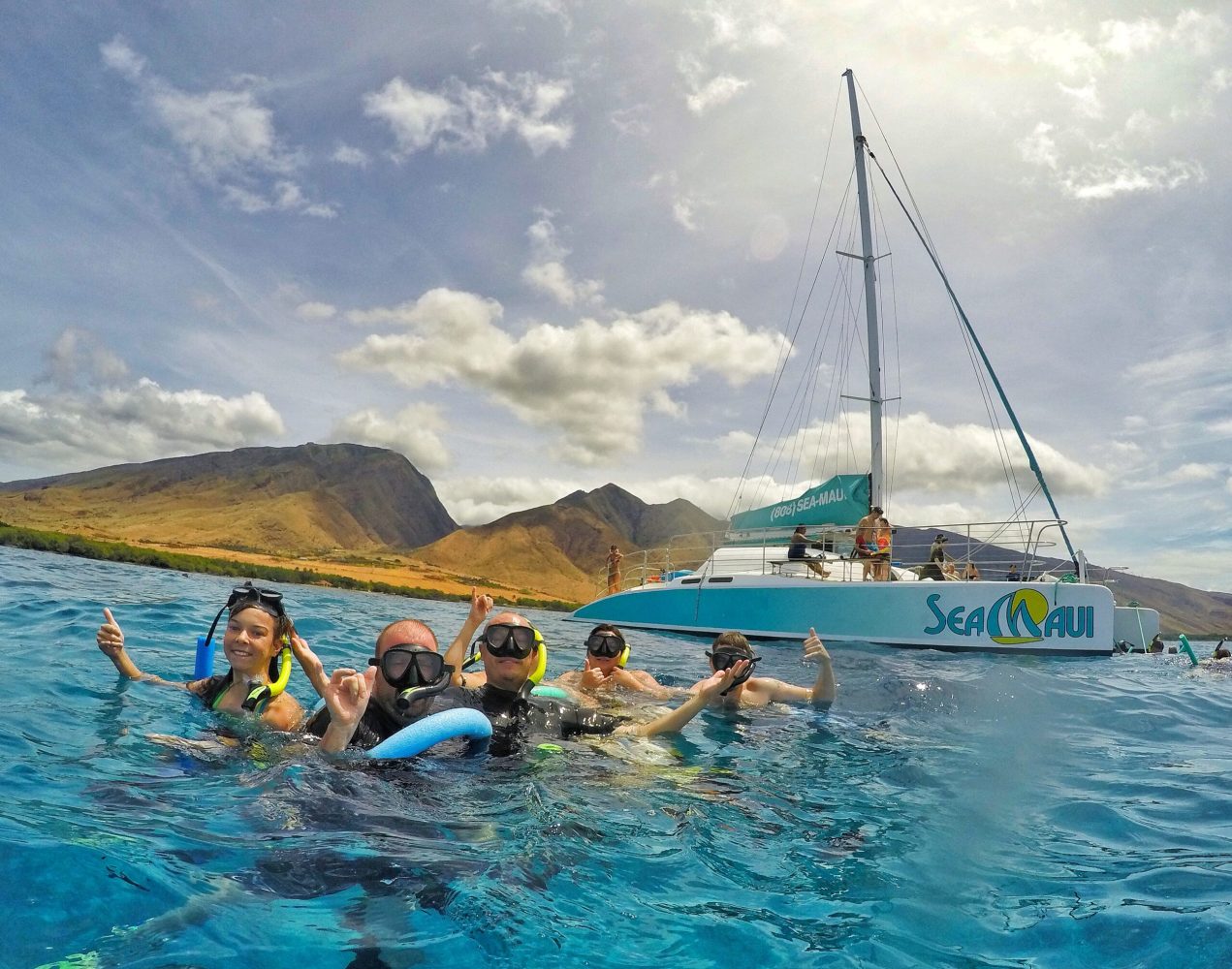 a group of people in a boat on a body of water