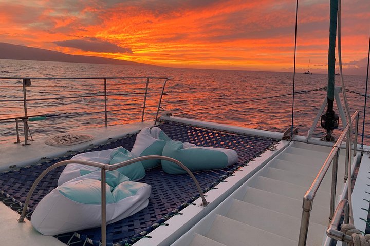 Sunset view from yacht deck with bean bags and netting.