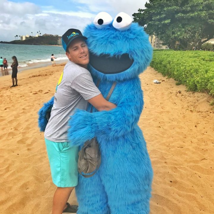 Person with cookie monster on beach