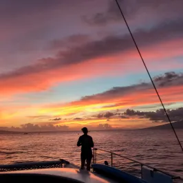 boat in water with sunset background