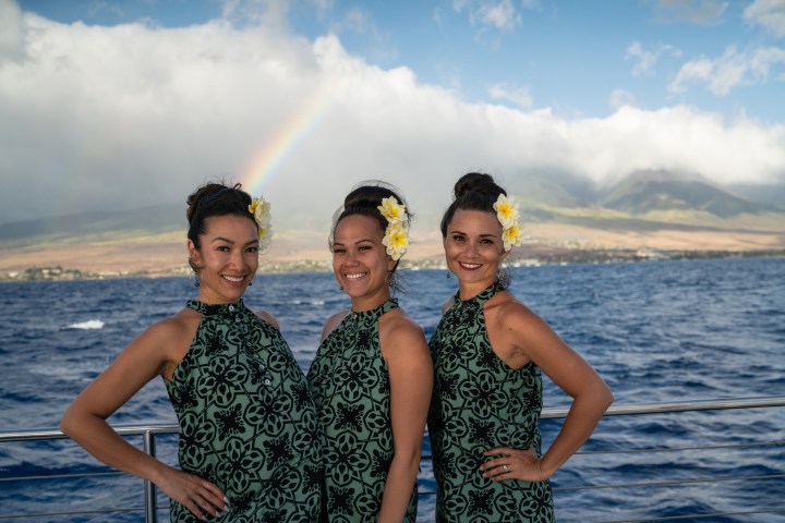 a man and a woman standing next to a body of water