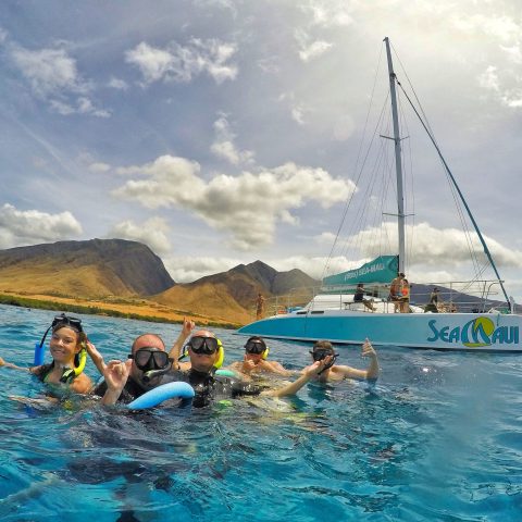 a group of people in a boat on a body of water