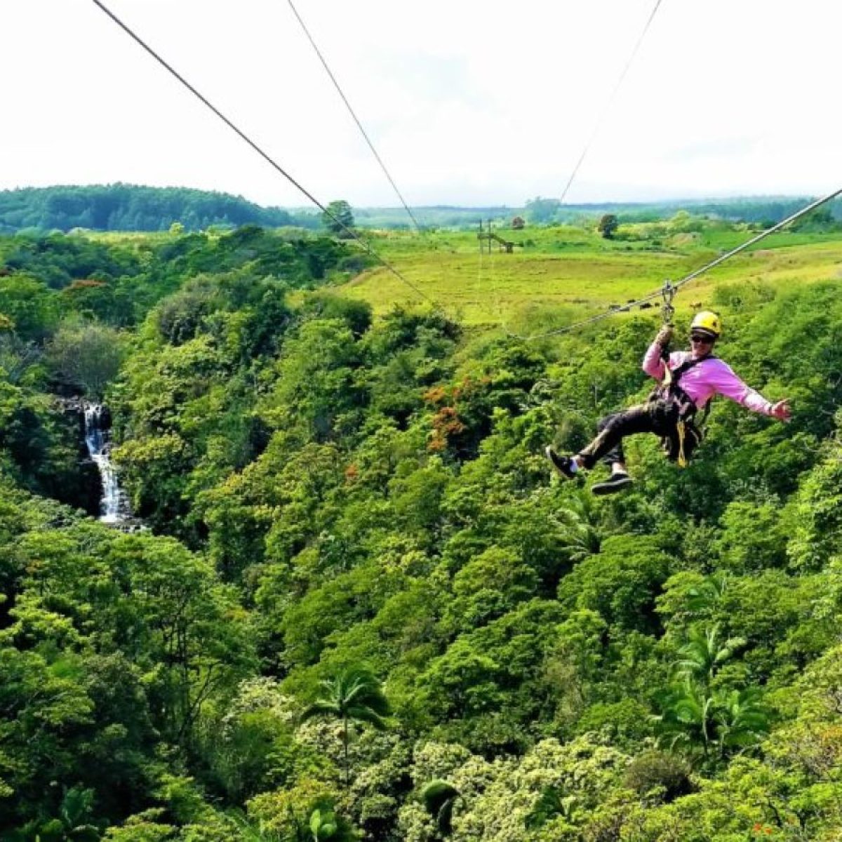 a person riding on top of a lush green field